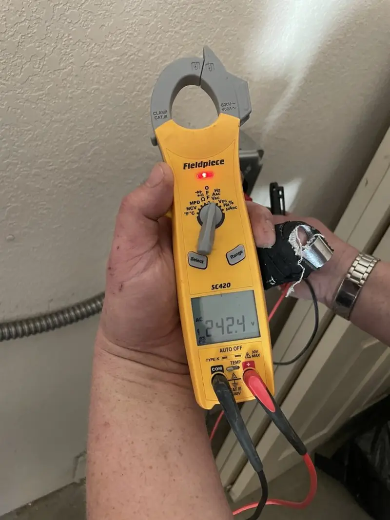 Voltage testing with clamp meter during Recessed Lighting Installation in Seneca